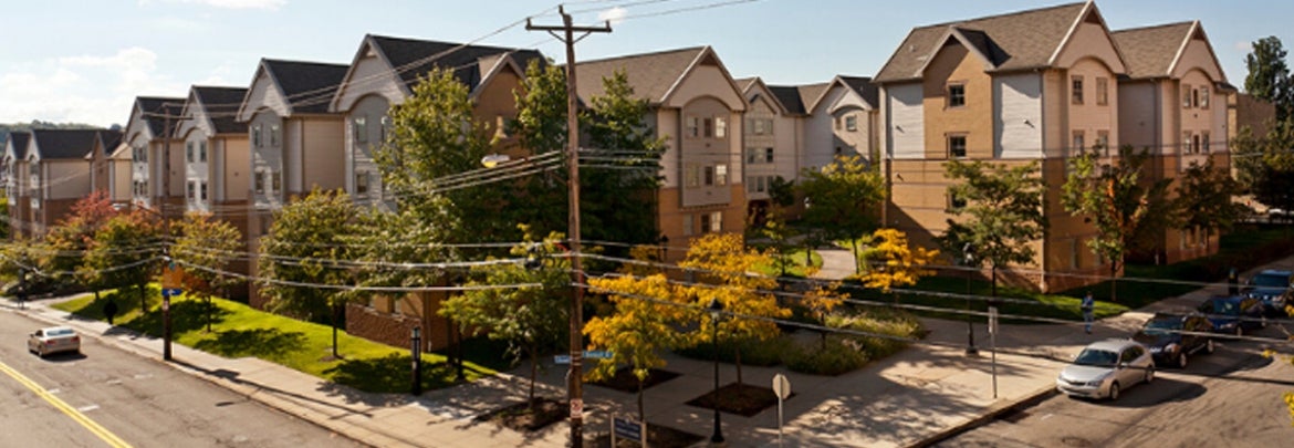 corner street with bright white and brown apartment buildings