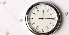 A photo of a clock and calendar used to express the passing of time. 